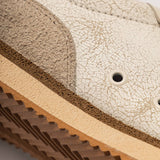 Detalhe da sola — EVA leve e borracha 100% natural
